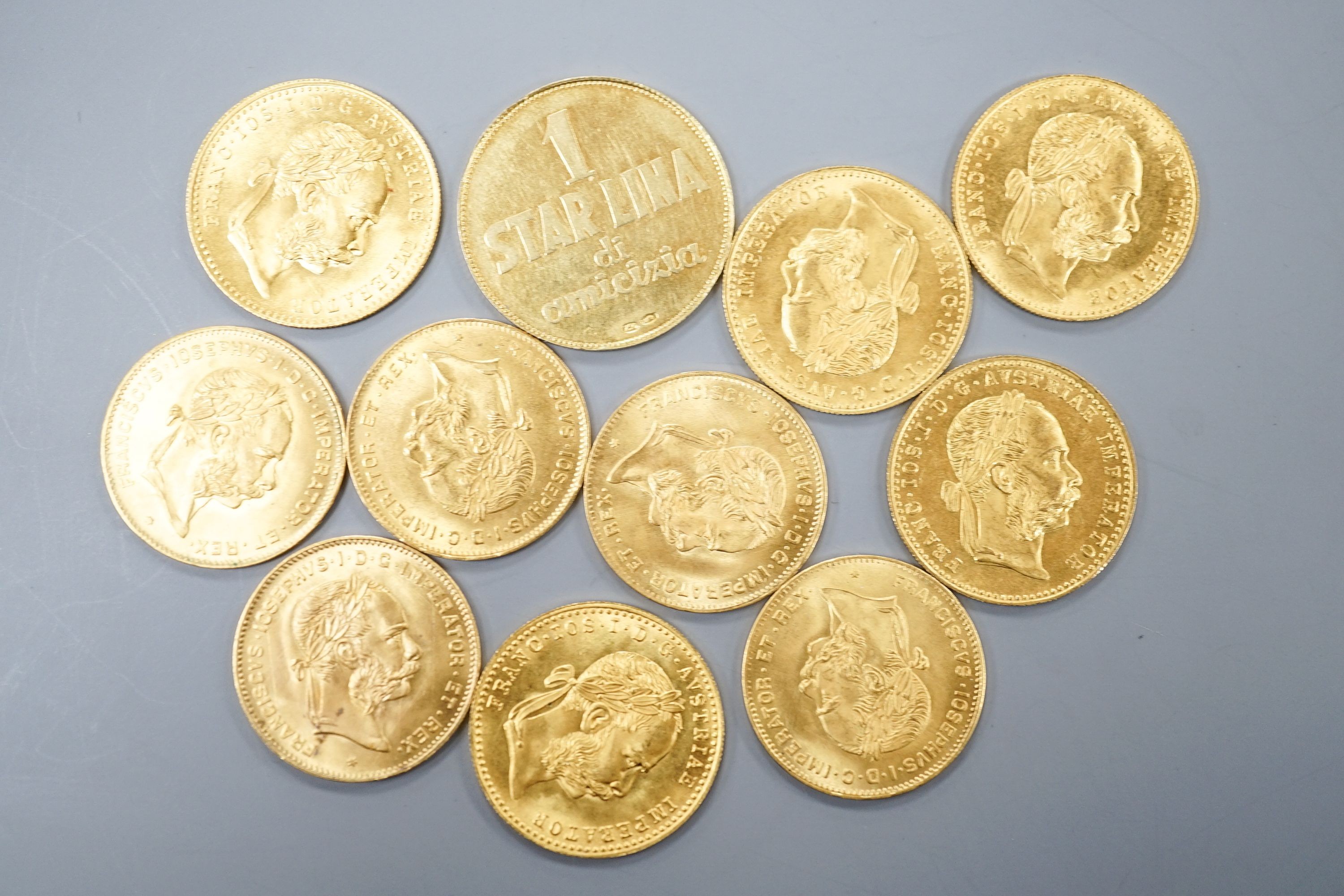Ten Austrian gold Ducats (re-strikes) and an Italian 750 yellow metal 'I Star Lina de Amicizia'